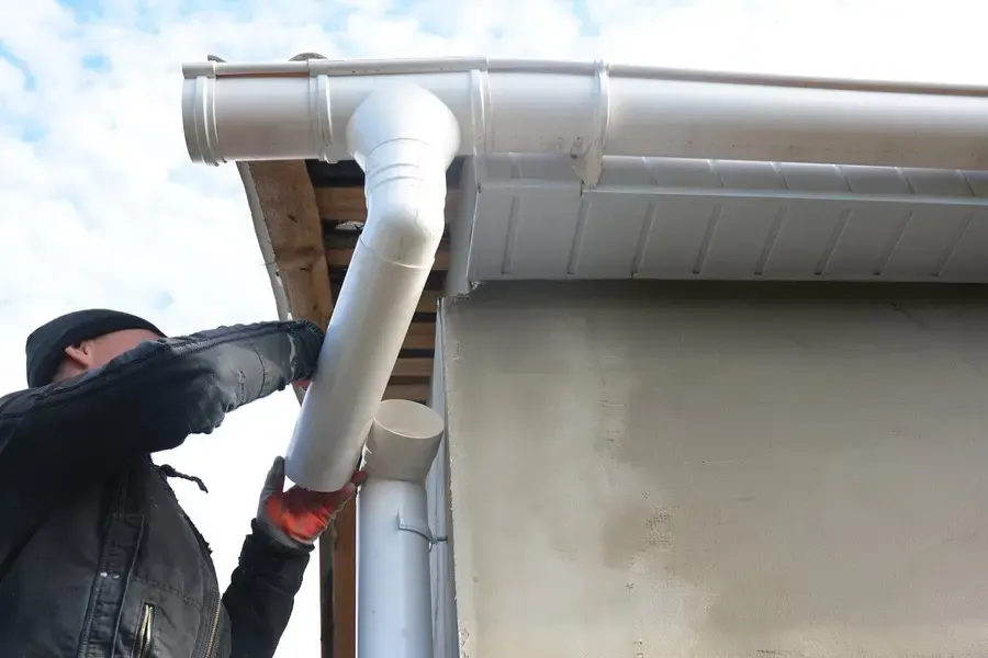 Clearing leaves from a clogged residential gutter