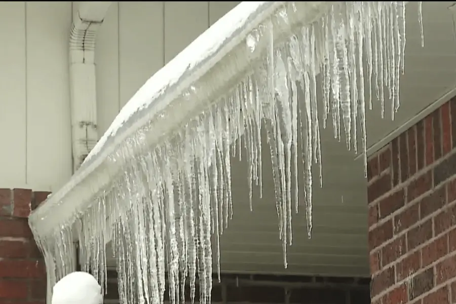 Ice collecting along a residential gutter edge